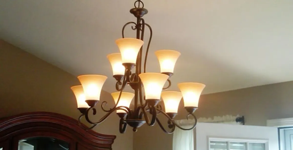 Classic ceiling chandelier installation with warm lighting in West Palm Beach, FL