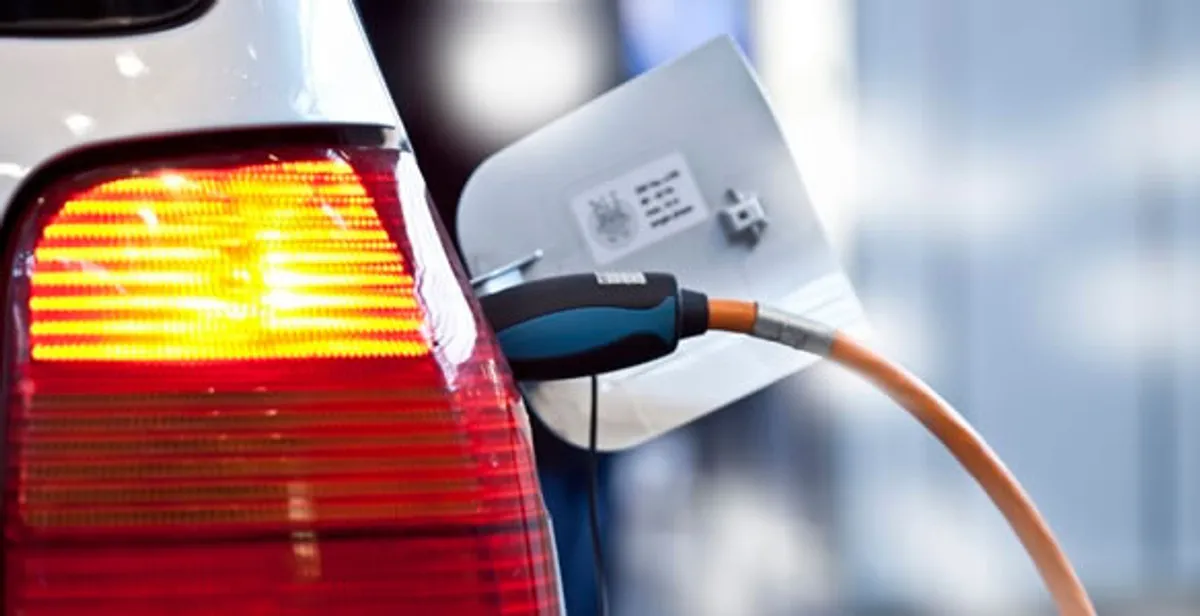 Electric car plugged into EV charger after professional installation in West Palm Beach, FL