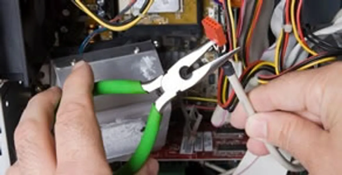 Licensed electrical contractor performing electrical repair with tools in Palm Beach Gardens, FL